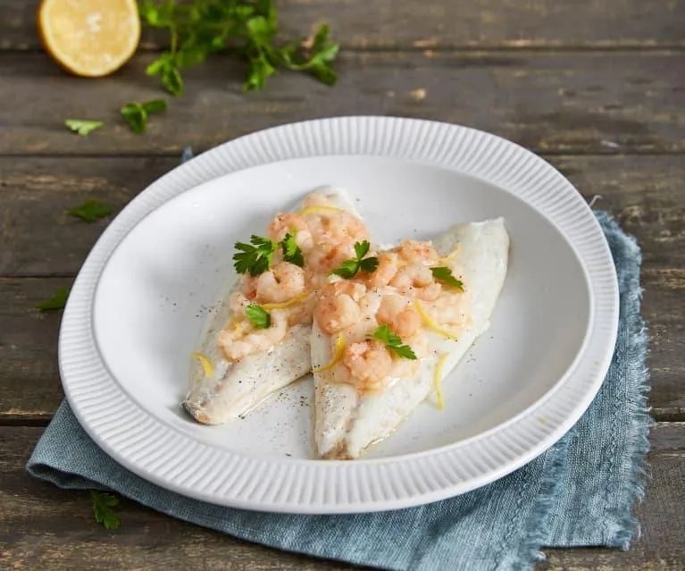 Fillet of white fish topped with shrimp, parsley and lemon